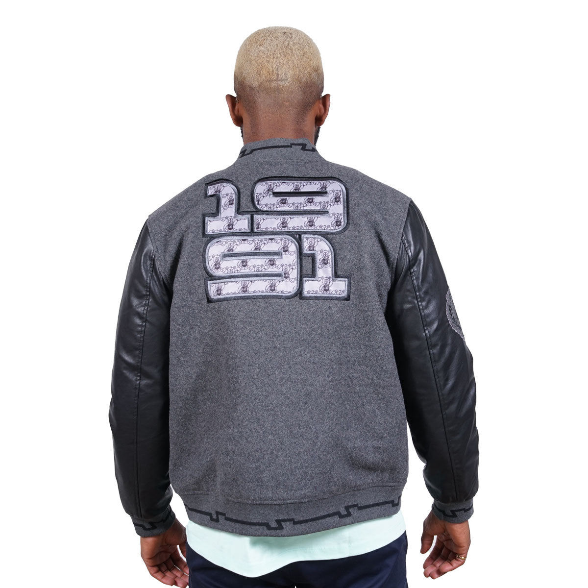 Back side of the Jacket, emblazoned with a fabric 1991 design. This jacket feels amazing to wear and looks great too. Grey body with black PU sleeves with a fabric inner lining.